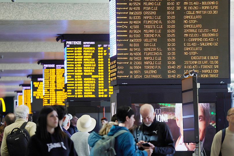 Stranded passengers look at train schedules during a general strike called by unions in solidarity with Global Sumud Flotilla at Termini train station in Rome, 3 October, 2025