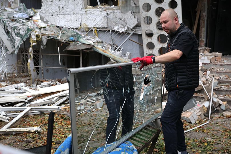 A local resident clears the rubble from the house destroyed by a Russian strike in Zaporizhzhia, Ukraine, Sunday, Oct. 5, 2025. 