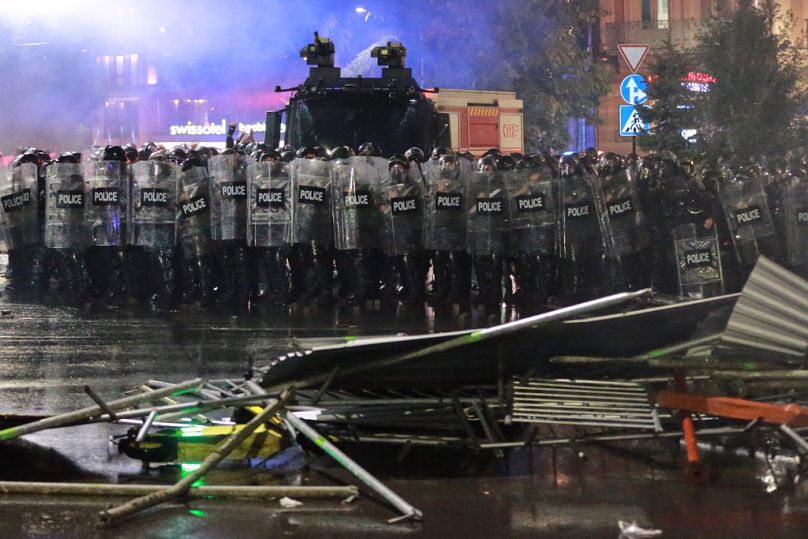 Police block a street to prevent demonstrators from advancing during an opposition rally in the city center of Tbilisi, Georgia, on Saturday, Oct. 4, 2025
