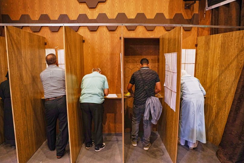 Electoral college members collect their ballots for a parliamentary election at a polling station in Aleppo, Syria, Sunday, Oct. 5, 2025