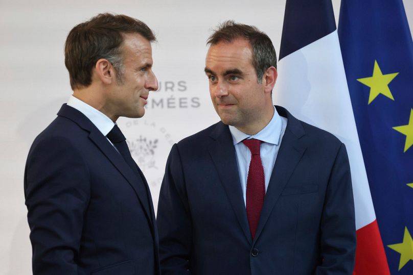 Then French Defence minister Sebastien Lecornu and President Emmanuel Macron talk at the end of an address by the president to army leaders in Paris, 13 July, 2025