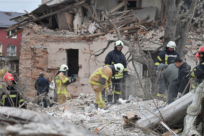 Rescuers search for victims in the debris of a destroyed house following a Russian rocket strike on the outskirts of Lviv, 5 October, 2025