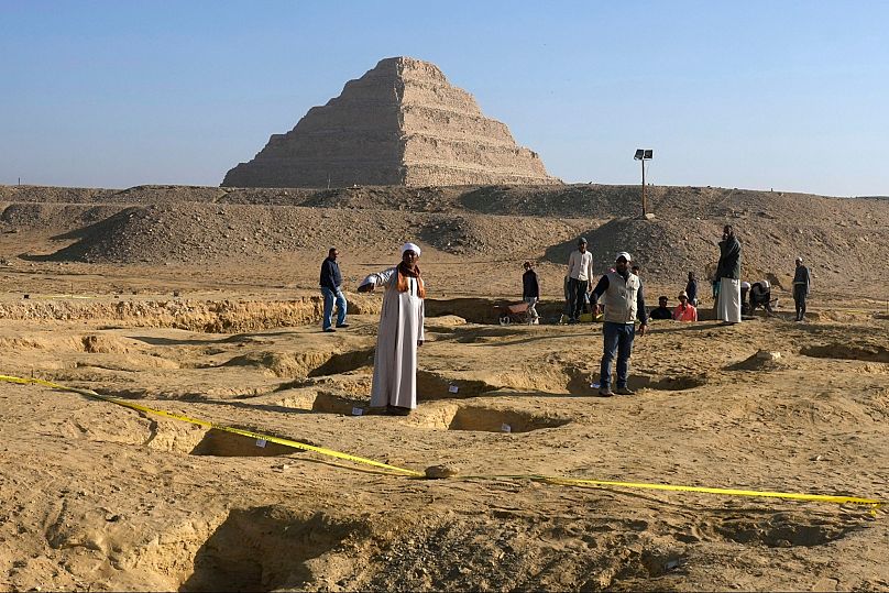 FILE - Egyptian antiquities workers dig at the site of the Step Pyramid of Djoser in Saqqara