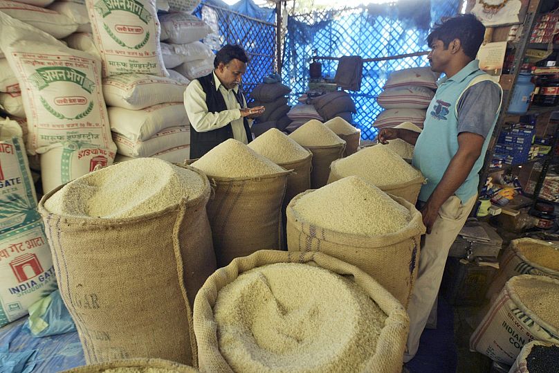FILE: A customer buys rice in a market in Allahabad, India, 1 April 2008