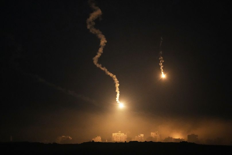Flares drift over the Gaza Strip illuminates the nigh sky, as seen from southern Israel, Tuesday, Oct. 7, 2025