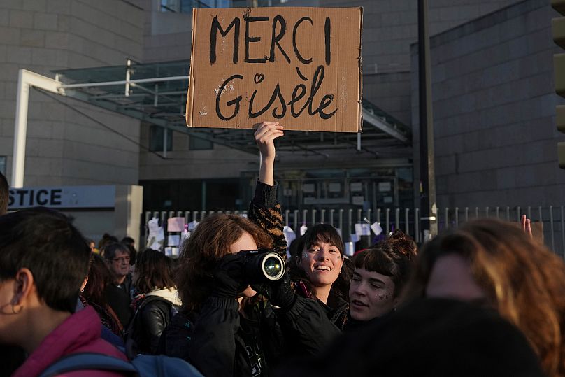 A woman holds a placard that reads, "Thank you Gisele," outside the Palace of Justice during a women's rights demonstration, Dec. 14, 2024, in Avignon, southern France.