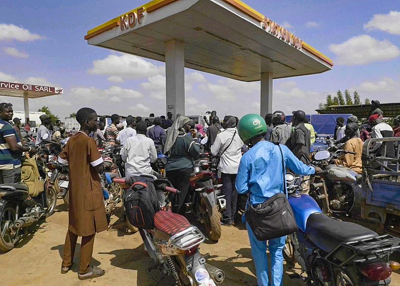 People queue with their motorbikes at a gas station amid a fuel shortage in Bamako, 7 October, 2025