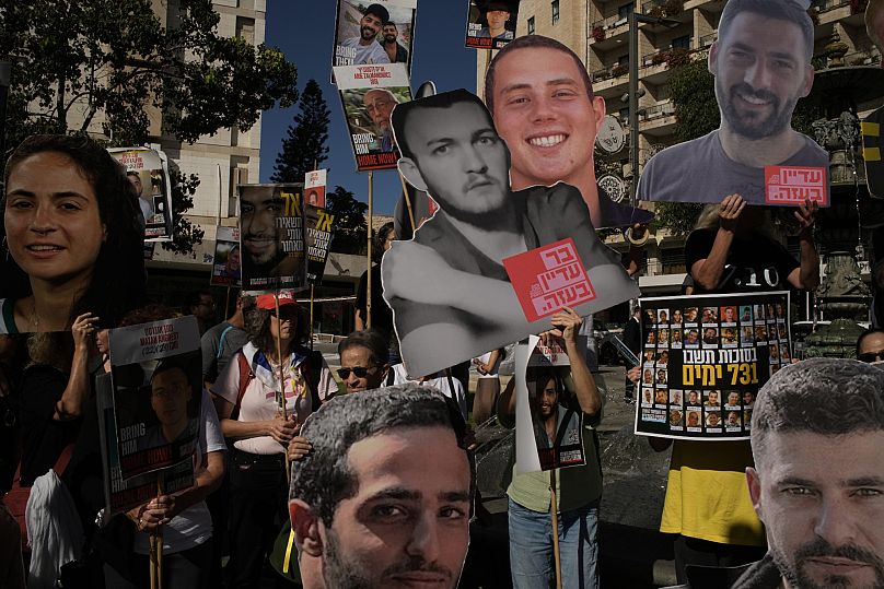 Relatives and supporters of Israeli hostages held by Hamas in the Gaza Strip carry posters with portraits of their loved ones during a protest in Jerusalem, 7 October, 2025
