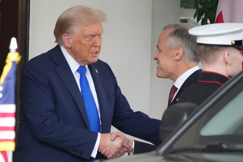 President Donald Trump greets Canada's Prime Minister Mark Carney, as he arrives at the White House, Tuesday, Oct. 7, 2025, in Washington