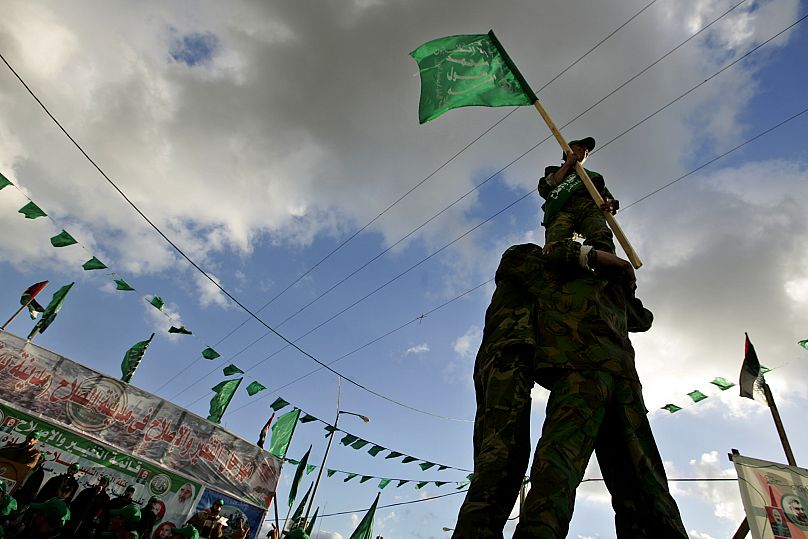 FILE: Palestinian youths of the Hamas movement perform a stunt during a rally in the northern Gaza Strip town of Beit Hanoun, 24 January 2005
