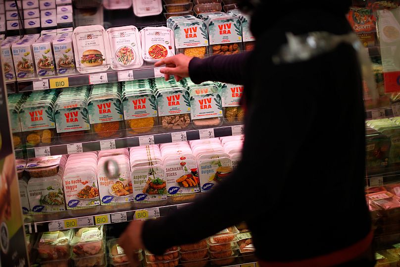 FILE: A store clerk shows plant based products at a supermarket chain in Brussels, 23 October 2020