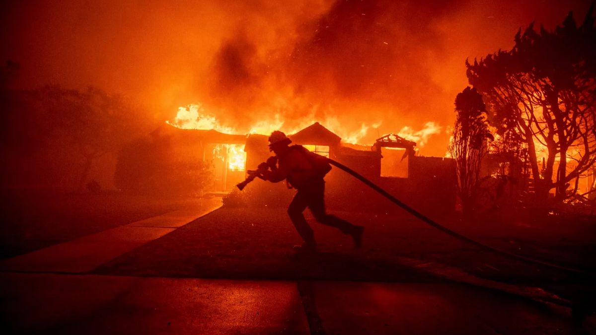 Authorities charge man with starting deadly fire that levelled wealthy LA neighbourhood