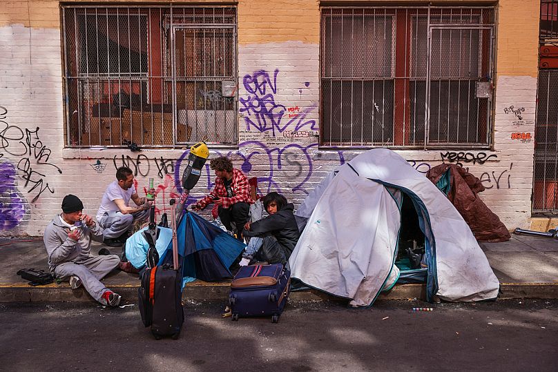 Drug users sit on the ground in Willow Alley in San Francisco, 13 March, 2024
