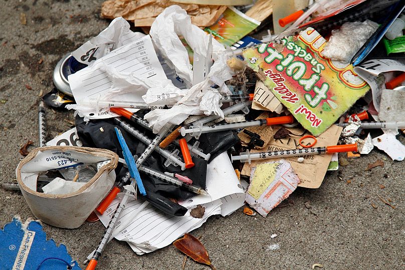 A number of syringes are scattered in the remains of a tent city being cleared by city workers along Division Street in San Francisco, 26 February, 2016