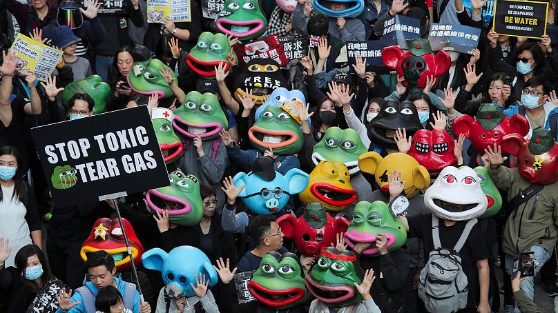 Pro-democracy protesters wear Pepe the Frog masks during a march in Hong Kong