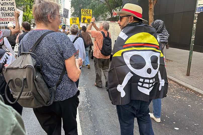 A protester outside the U.N. headquarters wears a One Piece flag as Benjamin Netanyahu speaks inside -26 September 2025