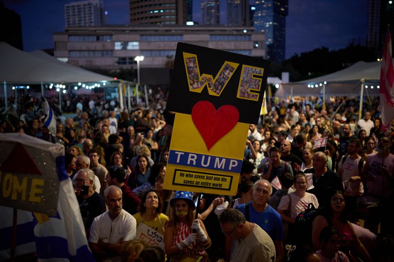 People gather to celebrate the deal on the first phase of a peace plan to pause the fighting, at a plaza known as Hostages Square in Tel Aviv, Israel, Thursday, Oct. 9, 2025