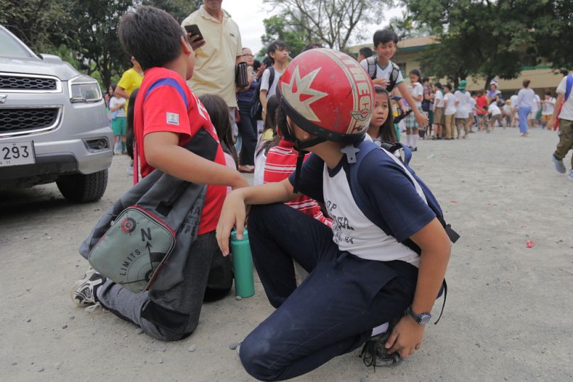 Children evacuate a school after a strong earthquake in Davao City, Philippines on Friday Oct. 10, 2025