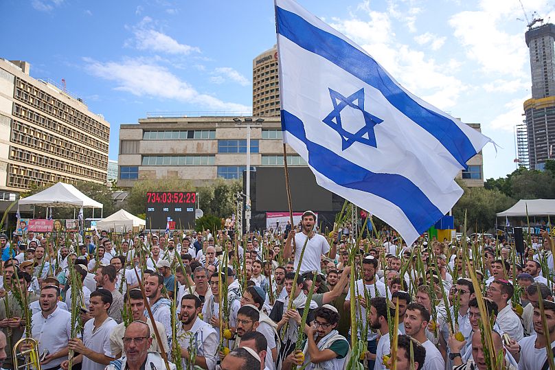 Israelis dance following the announcement that Israel and Hamas have agreed to the first phase of a peace plan in Tel Aviv, 10 October, 2025