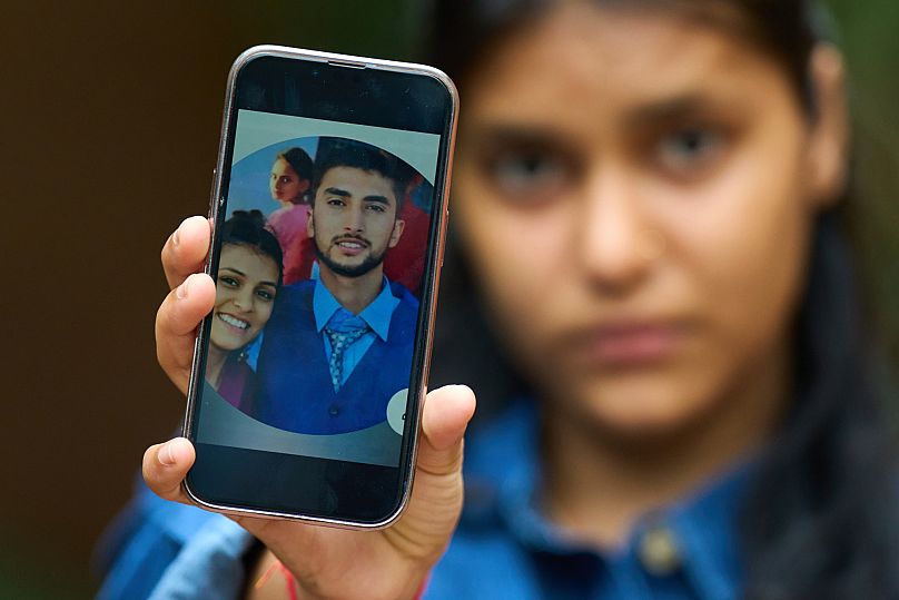 Pushpa Joshi, sister of Bipin Joshi, a Nepali man taken hostage by Hamas on Oct. 7, 2023, shows photos of them together in Kathmandu, Nepal, Thursday, June 12, 2025.
