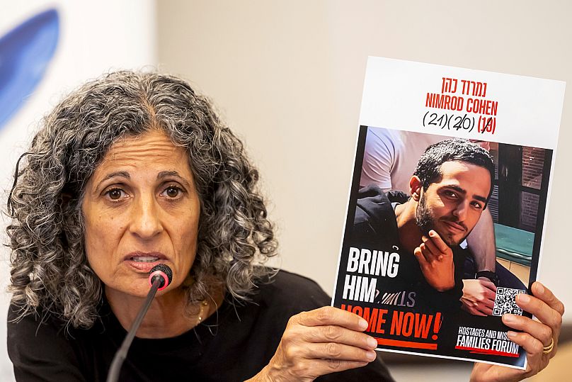 Viki Cohen mother of hostage Nimrod Cohen holds a picture of her son at the European headquarters of the United Nations in Geneva, Switzerland, Tuesday, Aug. 12, 2025.