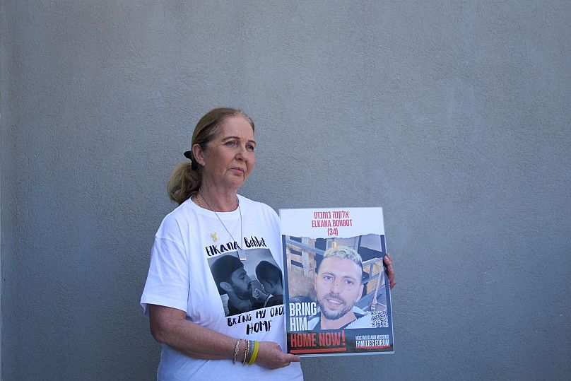 Ruhama Bohbot, mother of hostage Elkana Bohbot, poses for a portrait with his poster at her home in Mevaseret Zion, Israel, Wednesday, May 7, 2025.