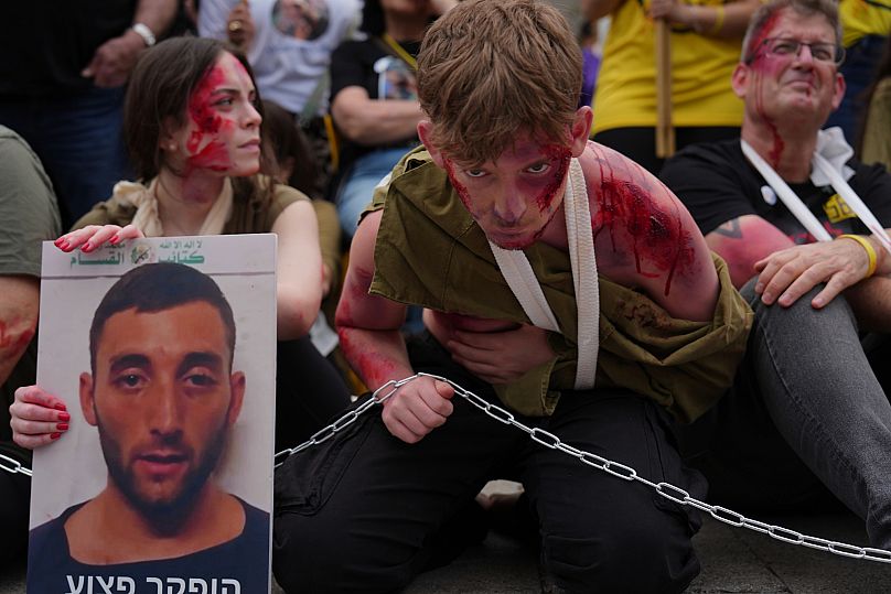Ofir Angrest wears fake blood and theatrical makeup at a demonstration calling for the release of his brother, Israeli soldier Matan Angrest, in Tel Aviv, April 21, 2025. 