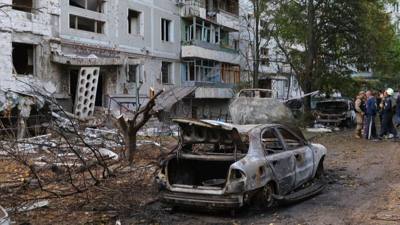 FILE: Burned cars and damaged residential building are seen after a Russian strike in Zaporizhzhia, Ukraine, Sunday, Oct. 5, 2025