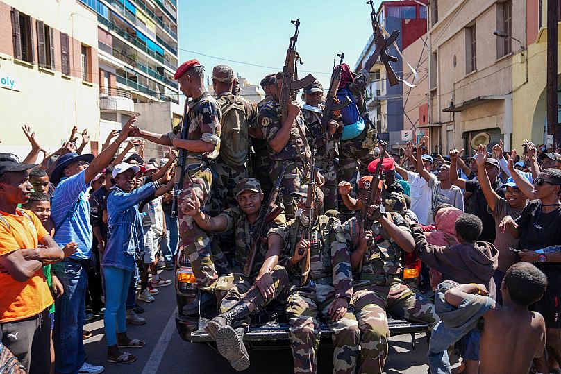 Soldiers are greeted by people gathering for a ceremony in tribute to demonstrators killed during recent anti-government protest in Antananarivo, Madagascar, Oct. 12, 2025.