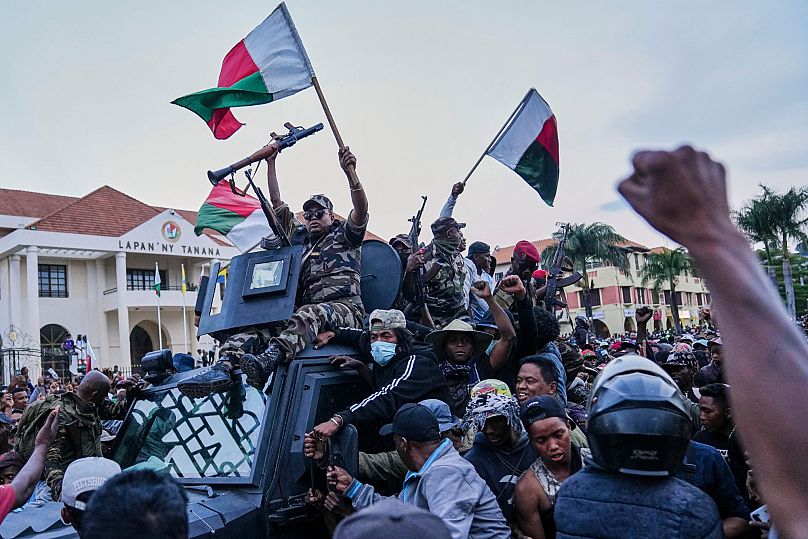 Soldiers are greeted by people gathering for a ceremony in tribute to demonstrators killed during recent anti-government protest in Antananarivo, Madagascar, Oct. 12,  2025.