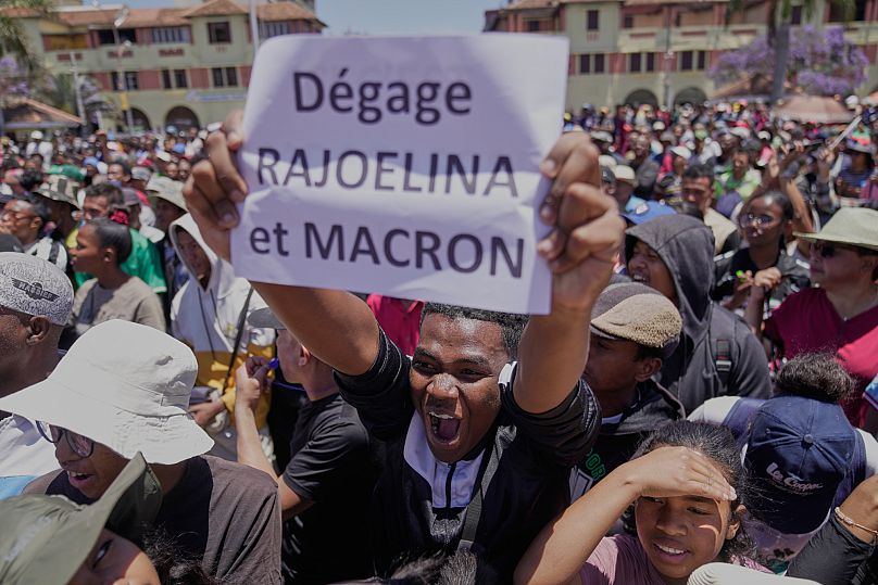 A protester displays a placard during a protest calling for President Andry Rajoelina to step down in Antananarivo, Madagascar, 14 October 2025