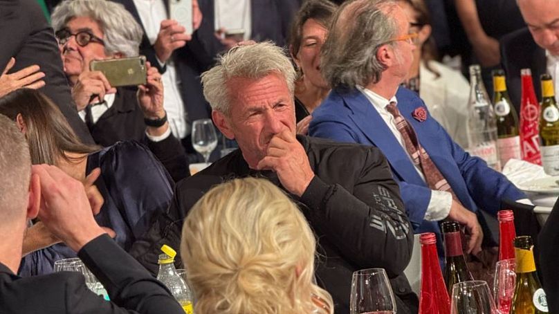 Sean Penn at the Lumiere opening ceremony dinner - reacting to the singing