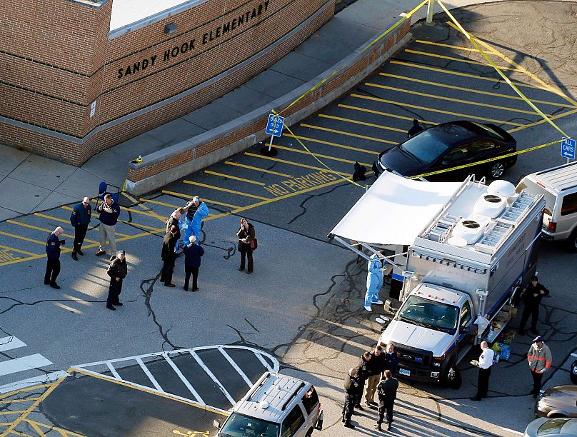 Officials stand outside of Sandy Hook Elementary School after a shooting in Newtown, 14 December, 2012