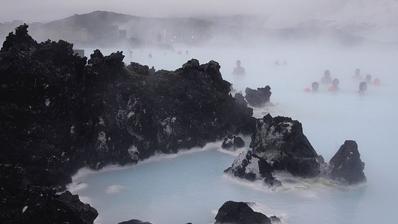 Tourists relax in the Blue Lagoon geothermal spa, Iceland on Feb. 21,2006