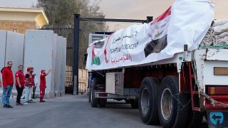 Aid trucks roll into Gaza after dispute over hostage bodies 