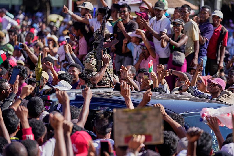 Members of the CAPSAT military unit are cheered by protesters as they arrive to address a crowd, announcing plans to take over the government and dissolve the Senate
