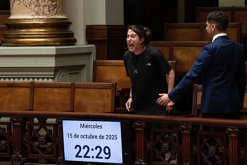 Egy nő "gyilkosokat" kiált, miután az uruguayi szenátus elfogadta az eutanáziát dekriminalizáló törvényt Montevideóban, 2025. október 15-én.
