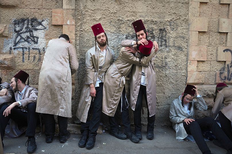 Ultra-Orthodox Jewish men celebrate the Jewish festival of Purim in Mea Shearim, ultra-Orthodox neighborhood in Jerusalem, Sunday, March 16, 2025. (AP Photo/Ohad Zwigenberg)