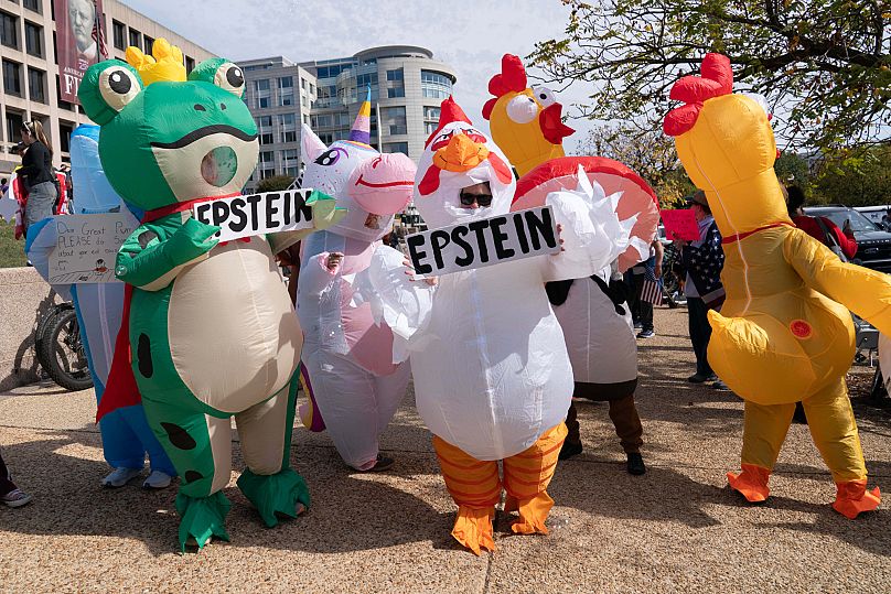 Demonstrators in inflatable costumes rally on Pennsylvania Avenue during a No Kings protest in Washington, Saturday, Oct. 18, 2025. 