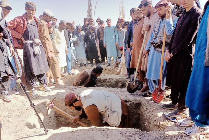 A população local cava sepulturas para as pessoas mortas num ataque aéreo transfronteiriço do exército paquistanês na província de Paktika, no leste do Afeganistão, no sábado, 18 de outubro de 2025