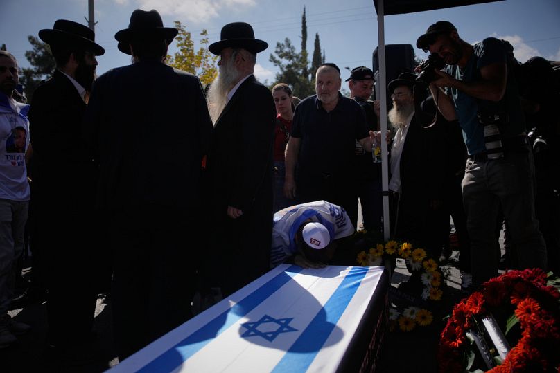 Mourners attend the funeral of slain hostage Uriel Baruch after his body was returned from Gaza, in Jerusalem, Sunday, Oct. 19, 2025
