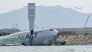 Cargo plane skids off Hong Kong runway, killing two airport workers