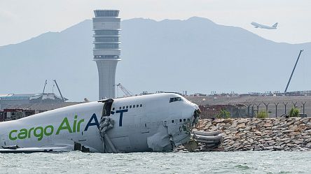 Cargo plane skids off Hong Kong runway, killing two airport workers