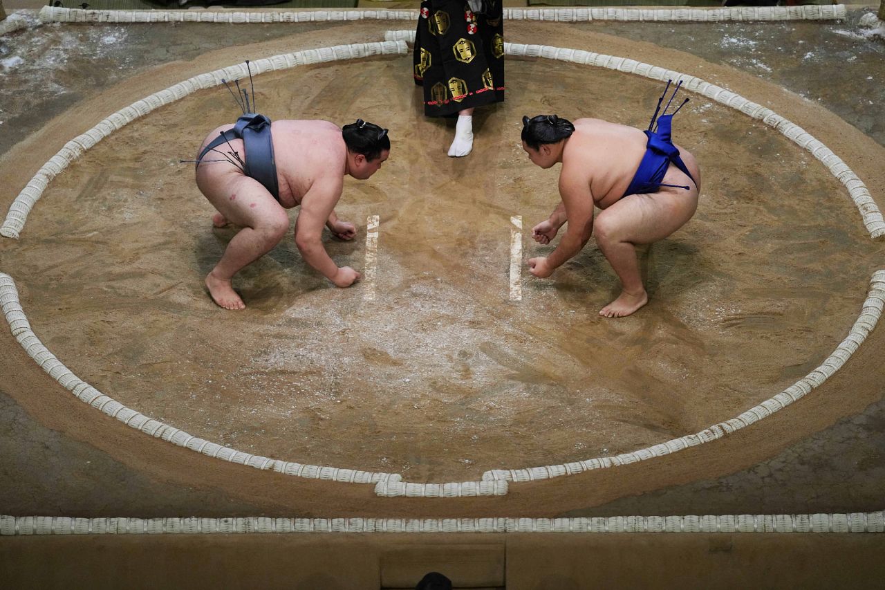 Sumo rikishi Kinbozan and Oshoma, right, during their Grand Sumo Tournament bout on the dohyo.