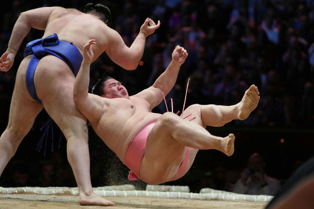 Sumo rikishi Aonishiki left, and Ura during their Grand Sumo Tournament bout on the dohyo