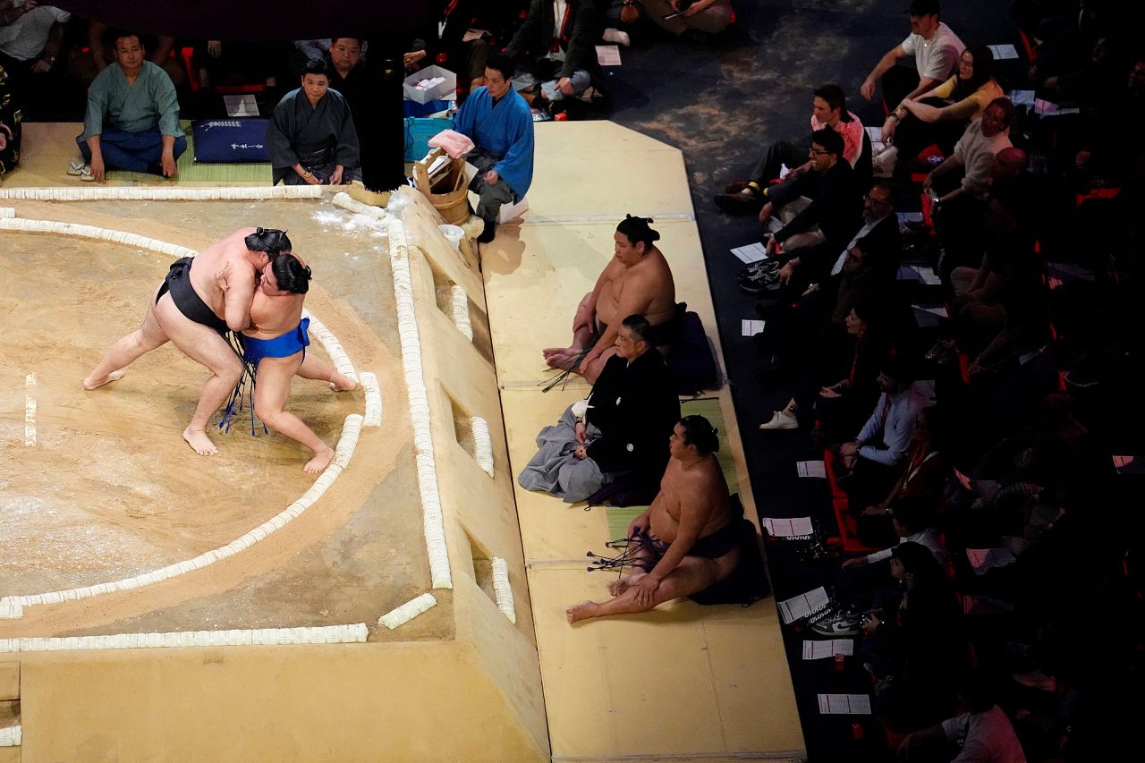 Ryuden battles with Fujinokawa in the Makuuchi Division bout on day three of the Grand Sumo Tournament 