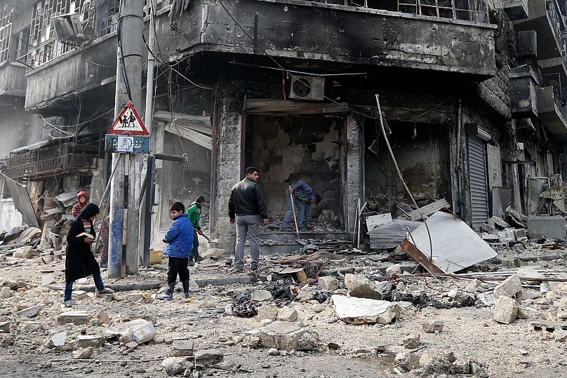 Syrian children remove rubble in the once rebel-held Bustan al-Qasr neighbourhood in eastern Aleppo, 20 January, 2017