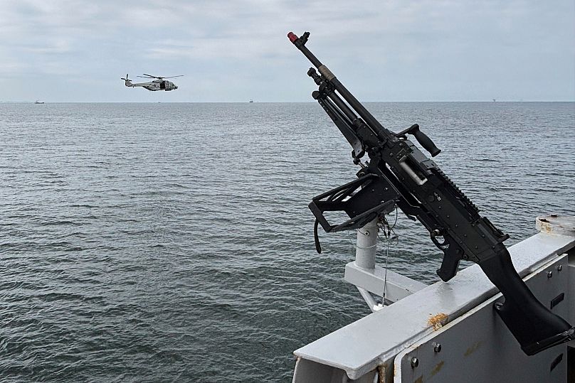 A helicopter flies by the HNLMS Tromp, a Royal Netherlands Navy guided missile frigate, patrolling in the North Sea, 19 June, 2025