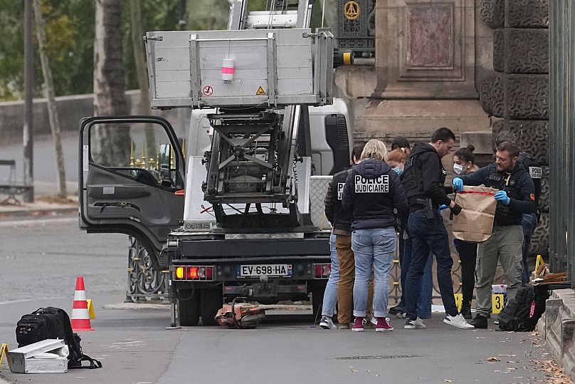 Police officers look for clues by a basket lift used by thieves Sunday, Oct. 19, 2025 at the Louvre museum in Paris. (AP Photo/Thibault Camus)