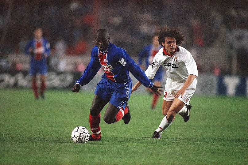 FILE: Ex-PSG striker George Weah, left, outruns Milan AC defender Paolo Maldini during their Champions League semifinals first leg match at the Parc des Prince
